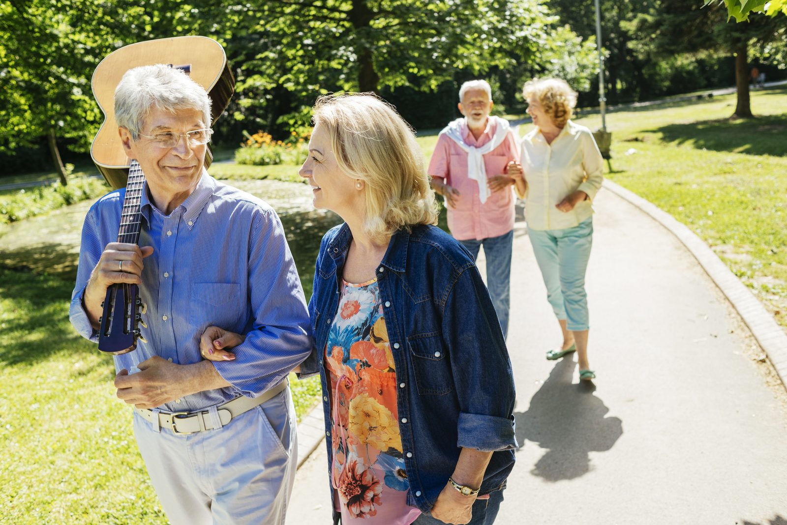 Residents walking together along a tree-lined path