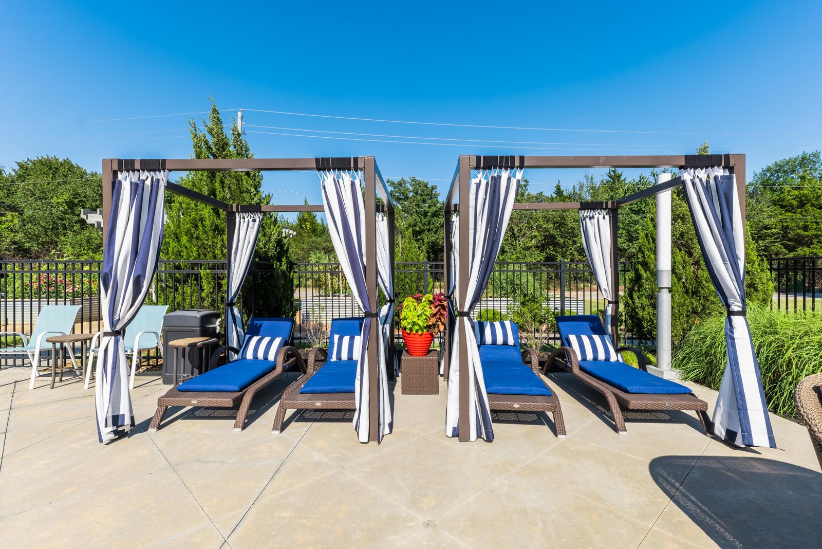 Poolside cabanas with blue loungers