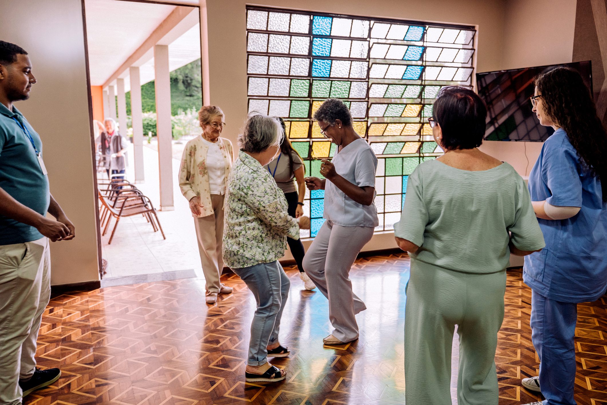 Residents dancing together in the community room